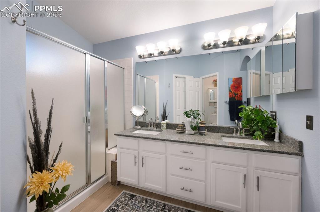 6370 Perfect View Colorado Springs, CO 80919 - Photo 20 of 49 a spacious bathroom with double vanity and a mirror