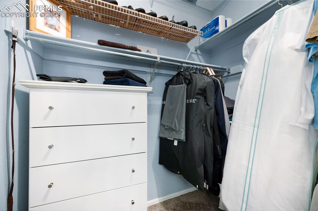 6370 Perfect View Colorado Springs, CO 80919 - Photo 22 of 49 a view of walk in closet with clothes and shoes