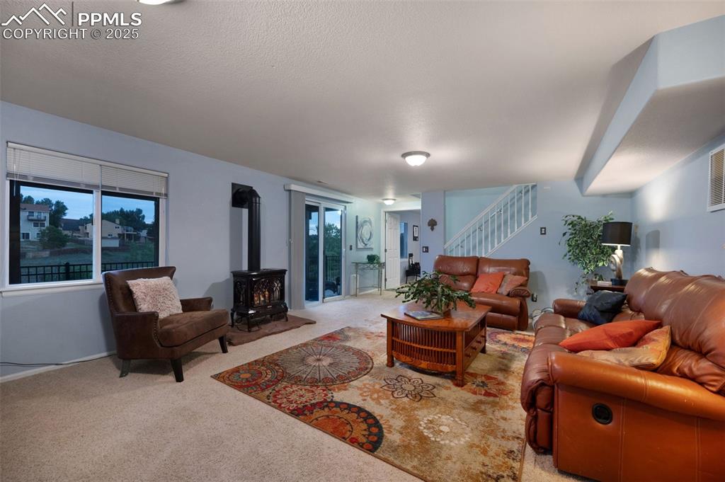 6370 Perfect View Colorado Springs, CO 80919 - Photo 27 of 49 a living room with furniture and a fireplace