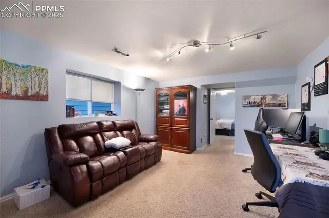 a livingroom with workspace and a couch