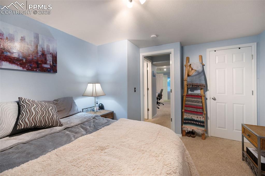 6370 Perfect View Colorado Springs, CO 80919 - Photo 32 of 49 a bedroom with a bed and a walk in closet