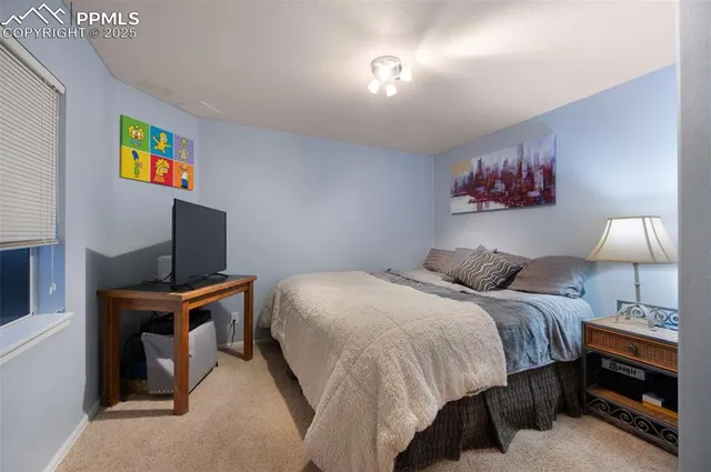 a bedroom with a bed and a desk