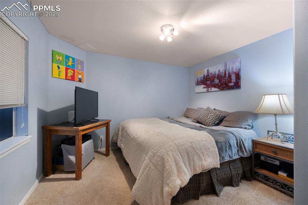 6370 Perfect View Colorado Springs, CO 80919 - Photo 33 of 49 a bedroom with a bed and a desk