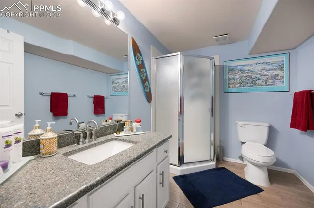 a spacious bathroom with a granite countertop sink and a mirror