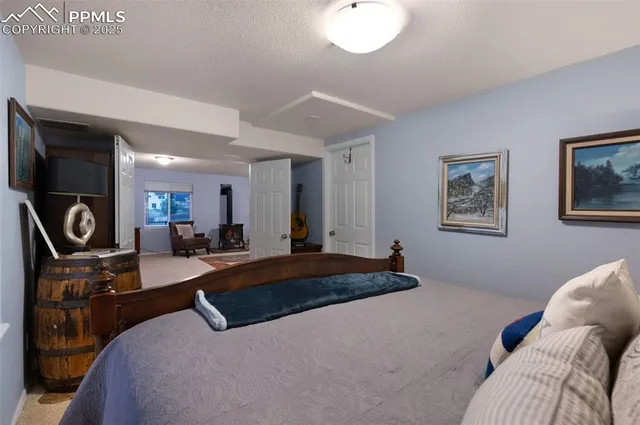 a bedroom with a bed gym equipment and mirror