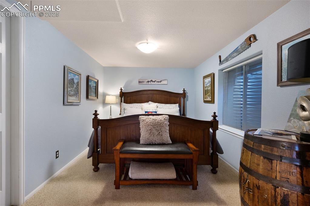 6370 Perfect View Colorado Springs, CO 80919 - Photo 36 of 49 a bedroom with furniture and paintings on the wall