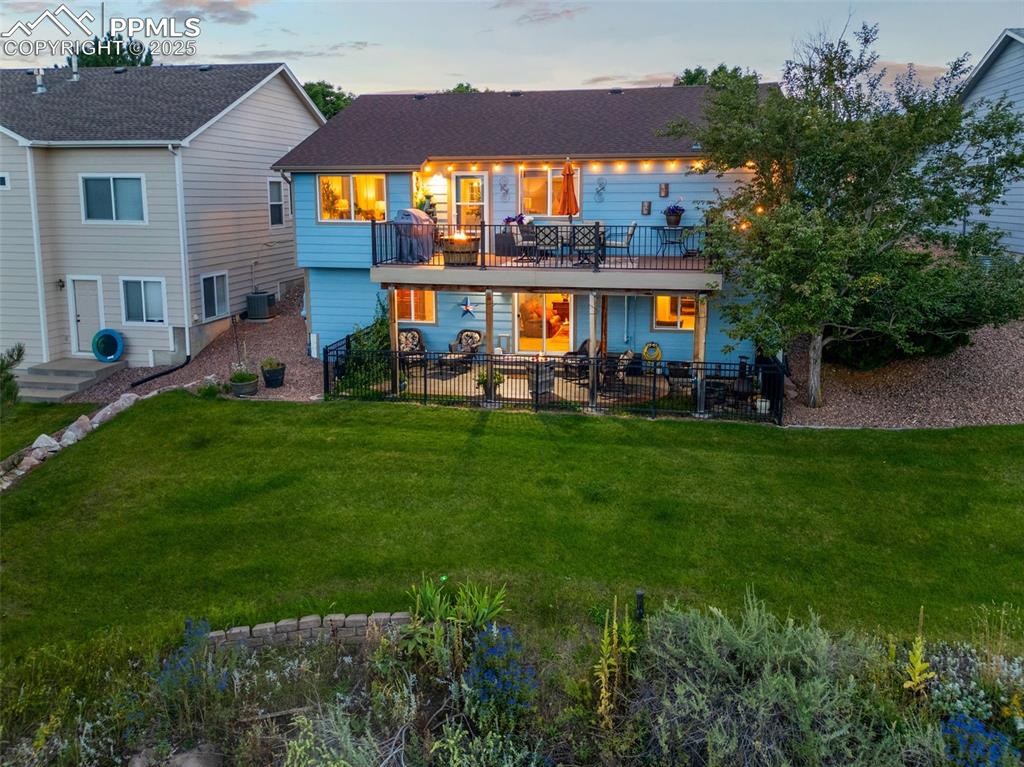 6370 Perfect View Colorado Springs, CO 80919 - Photo 43 of 49 a view of a house with a yard