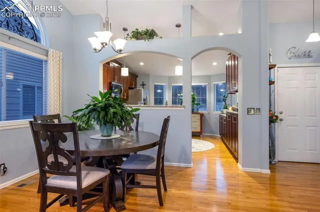 a view of a dining room with furniture and wooden floor