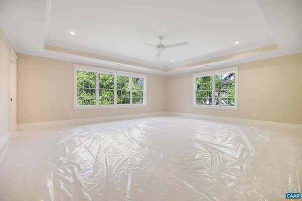 an empty room with windows and cabinet