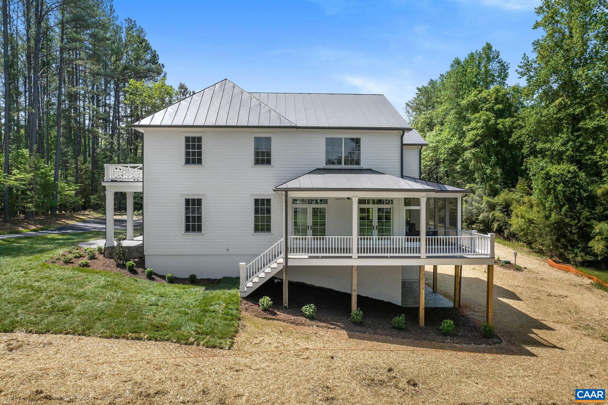 3.12 Acres Tbb Garth Road Charlottesville, VA 22901 - Photo 38 of 52 a front view of a house with a yard table and chairs