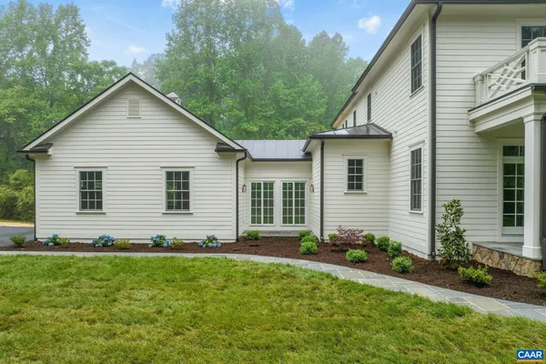 a aerial view of a house with a yard and trees