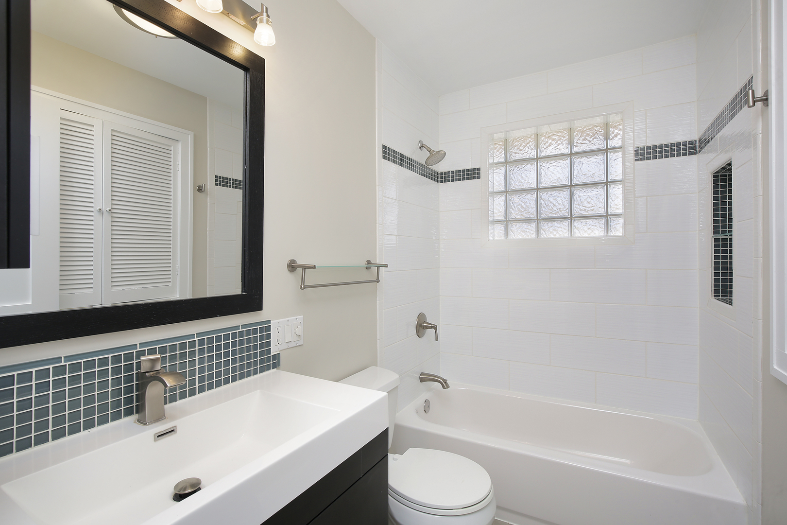 1342 Kenton Road Deerfield, IL 60015 - Photo 7 of 12 a bathroom with a bathtub a sink a toilet and a window