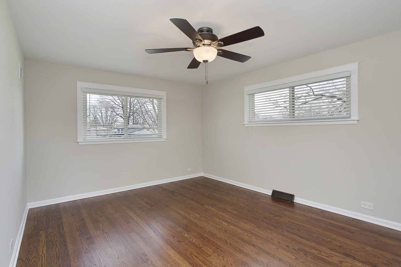 1342 Kenton Road Deerfield, IL 60015 - Photo 8 of 12 a view of an empty room with wooden floor and a ceiling fan