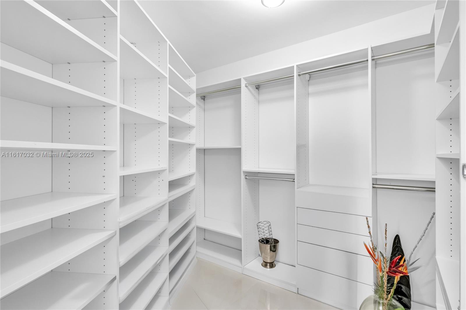 18911 Collins Avenue, Unit 1003 Sunny Isles Beach, FL 33160 - Photo 12 of 47 a view of walk in closet with empty racks