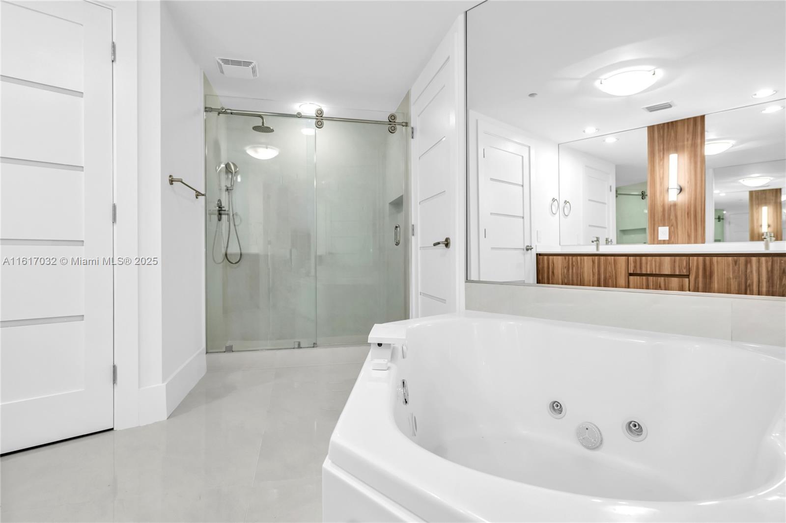 18911 Collins Avenue, Unit 1003 Sunny Isles Beach, FL 33160 - Photo 14 of 47 a bathroom with a bathtub and a shower