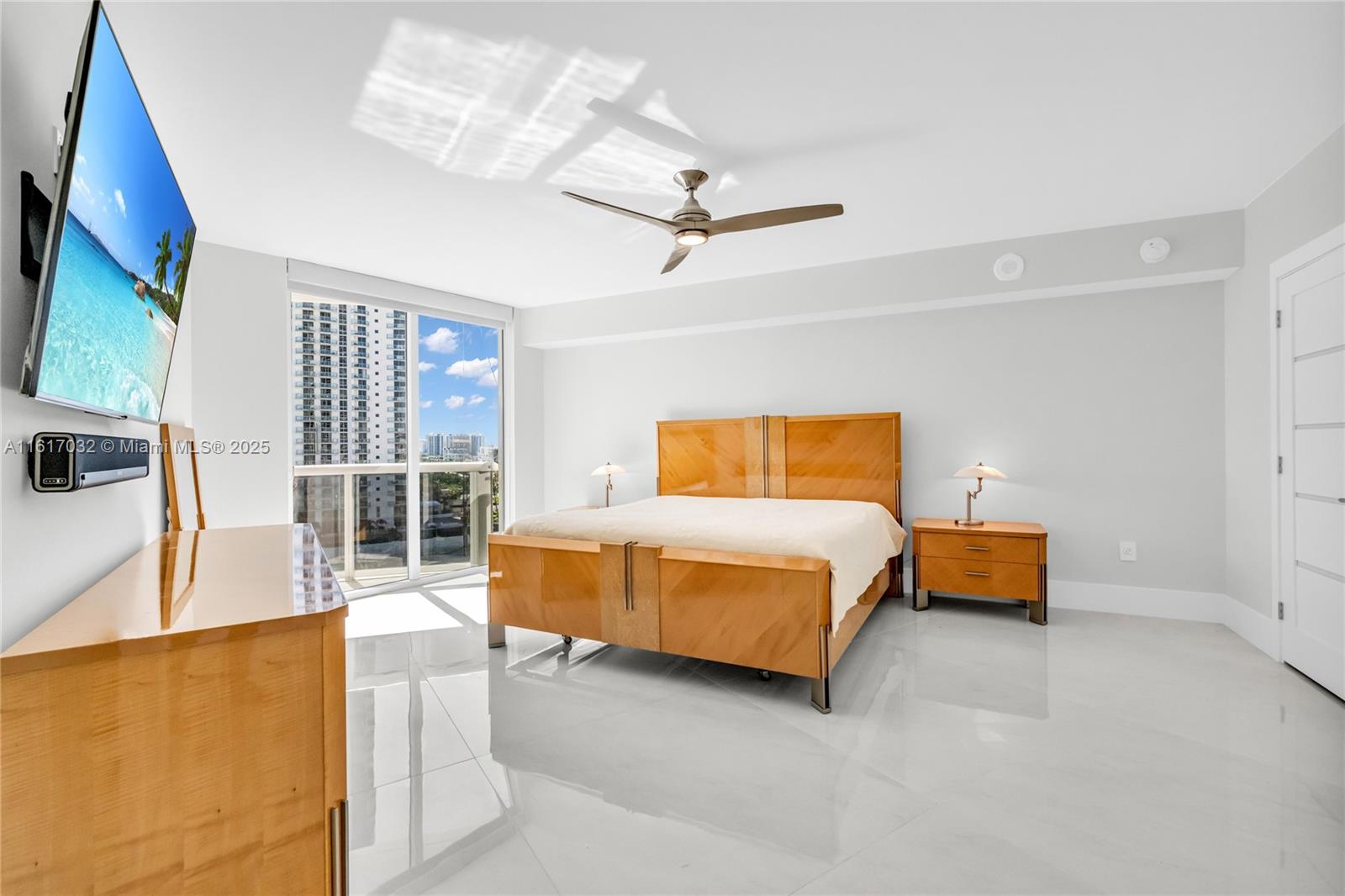 18911 Collins Avenue, Unit 1003 Sunny Isles Beach, FL 33160 - Photo 17 of 47 a bedroom with a bed and wooden floor