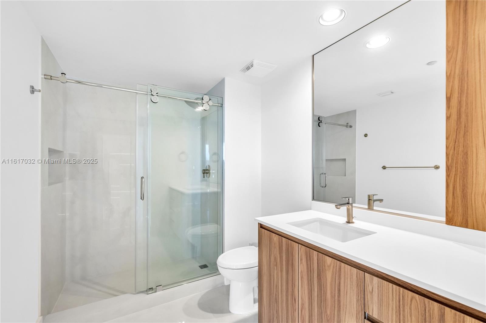 18911 Collins Avenue, Unit 1003 Sunny Isles Beach, FL 33160 - Photo 19 of 47 a bathroom with a sink a toilet and shower