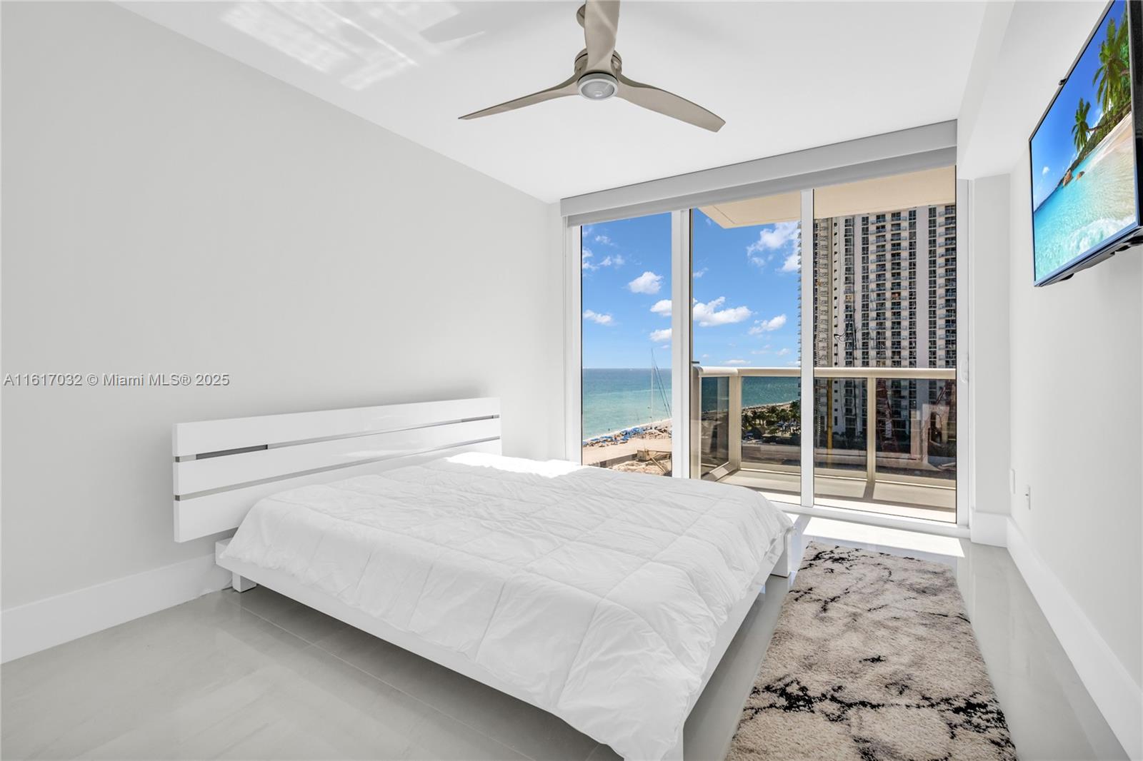 18911 Collins Avenue, Unit 1003 Sunny Isles Beach, FL 33160 - Photo 21 of 47 a bedroom with a bed and a large window