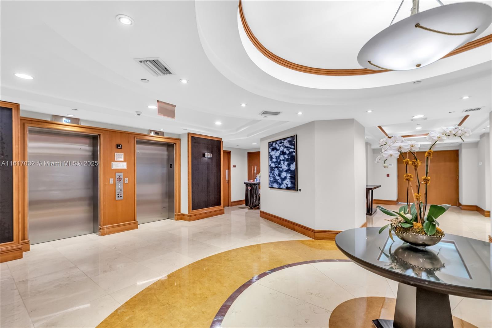 18911 Collins Avenue, Unit 1003 Sunny Isles Beach, FL 33160 - Photo 22 of 47 a bedroom with a bed dresser and a mirror