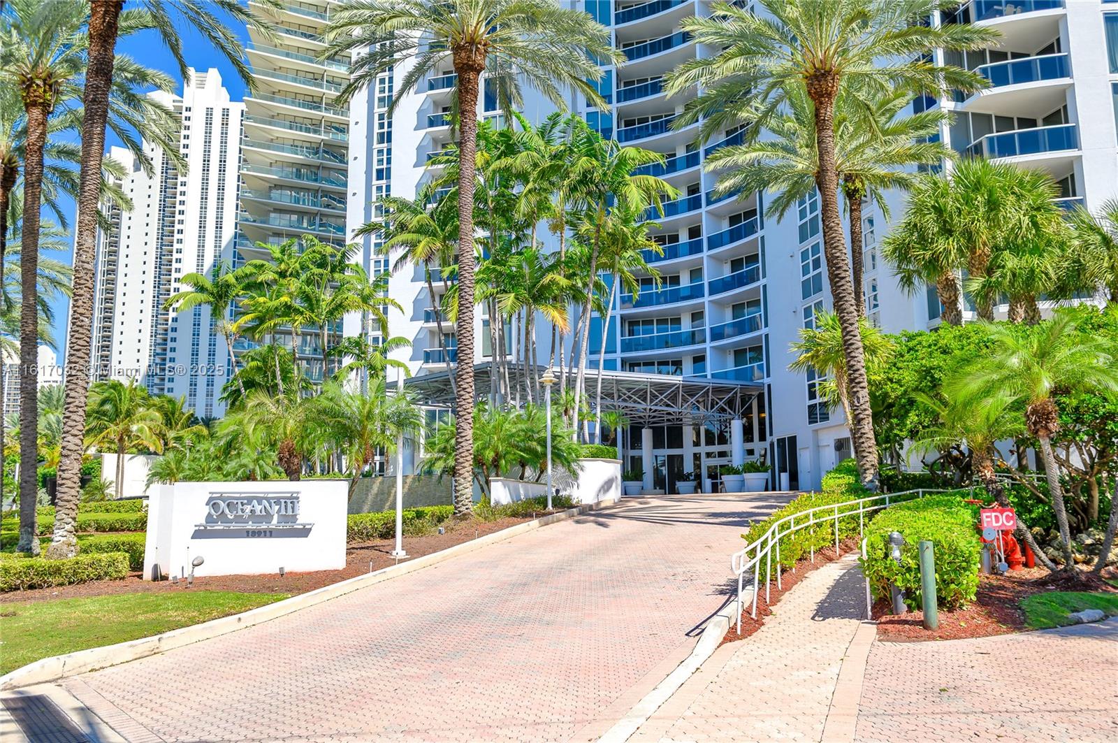 18911 Collins Avenue, Unit 1003 Sunny Isles Beach, FL 33160 - Photo 27 of 47 a view of a building with a garden and plants