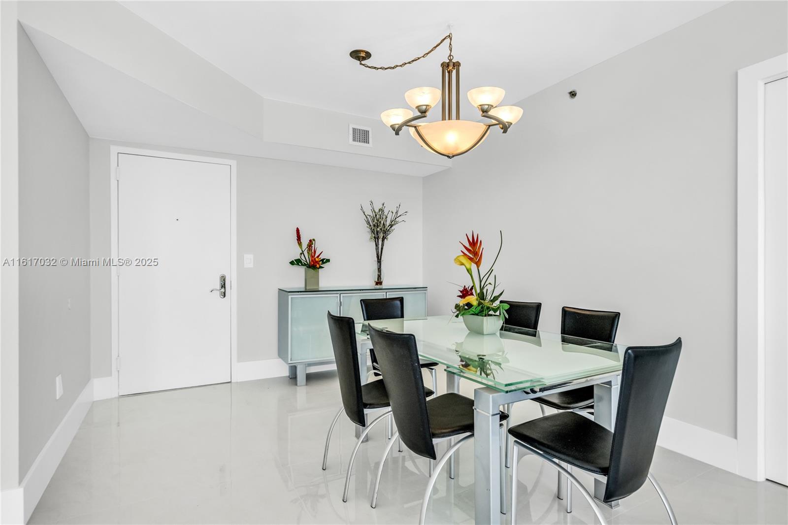 18911 Collins Avenue, Unit 1003 Sunny Isles Beach, FL 33160 - Photo 5 of 47 a view of a dining room with furniture and wooden floor