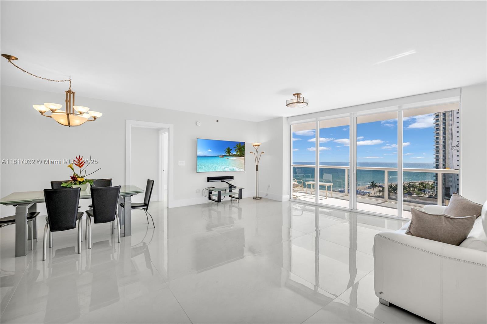 18911 Collins Avenue, Unit 1003 Sunny Isles Beach, FL 33160 - Photo 9 of 47 a dining room with furniture and a large window