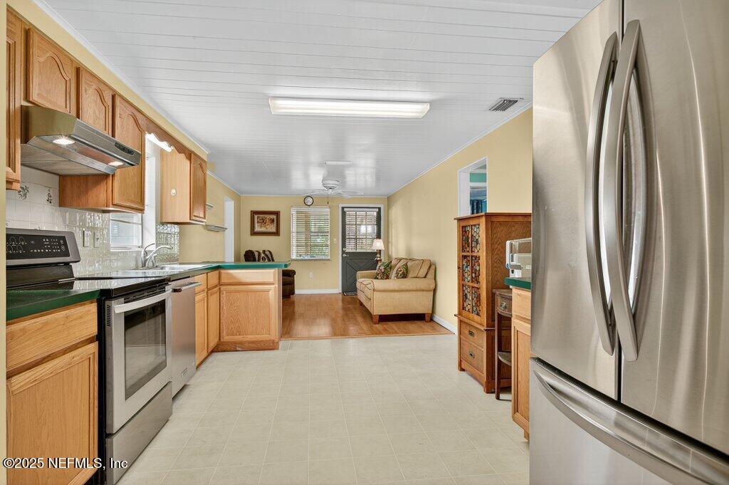 24480 Northeast 127 Street Salt Springs, FL 32134 - Photo 20 of 59 a kitchen with stainless steel appliances granite countertop a refrigerator a stove and a sink