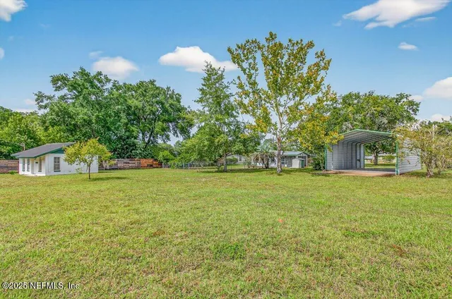 a front view of a house with a garden and trees