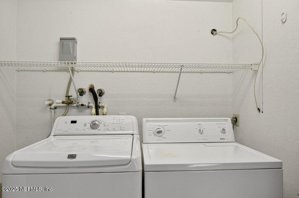 24480 Northeast 127 Street Salt Springs, FL 32134 - Photo 24 of 59 a close up view of washer and dryer with bathtub in the background