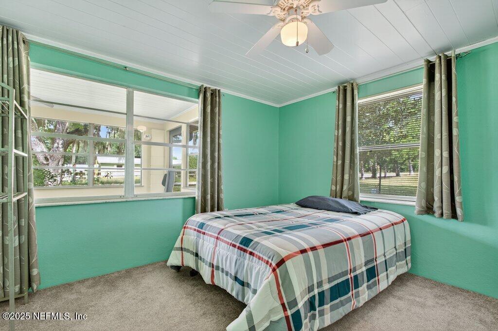 24480 Northeast 127 Street Salt Springs, FL 32134 - Photo 27 of 59 a bedroom with a bed and a window