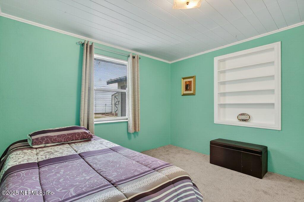 24480 Northeast 127 Street Salt Springs, FL 32134 - Photo 29 of 59 a bedroom with a bed and a window