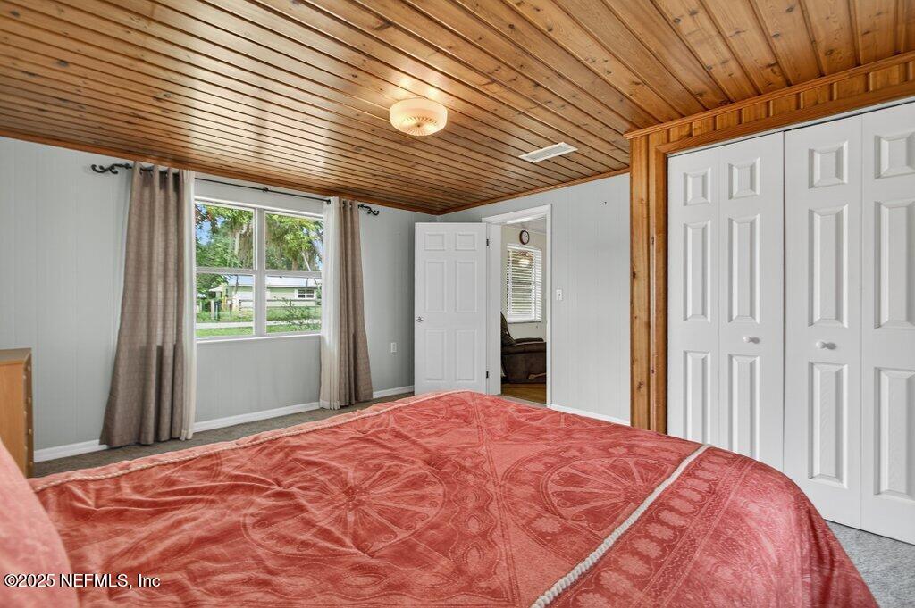 24480 Northeast 127 Street Salt Springs, FL 32134 - Photo 33 of 59 a bedroom with a large bed and a large window
