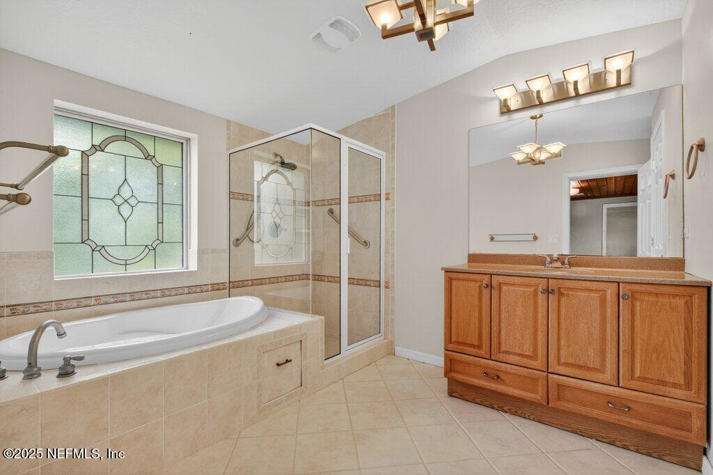 24480 Northeast 127 Street Salt Springs, FL 32134 - Photo 34 of 59 a spacious bathroom with a tub sink and mirror
