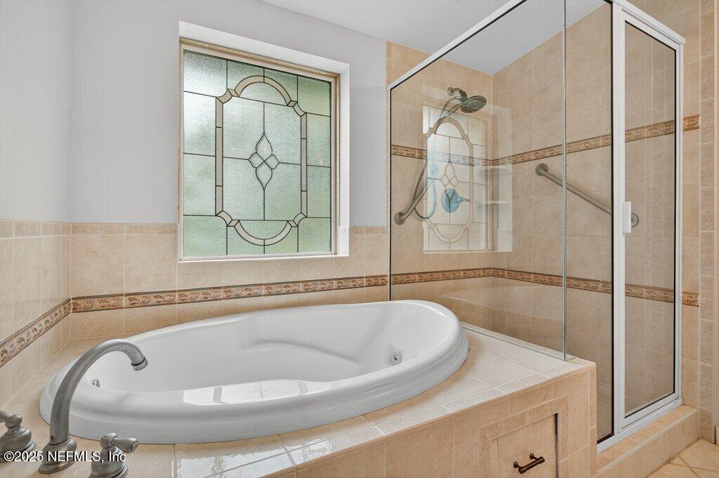 24480 Northeast 127 Street Salt Springs, FL 32134 - Photo 35 of 59 a bathroom with a tub and shower