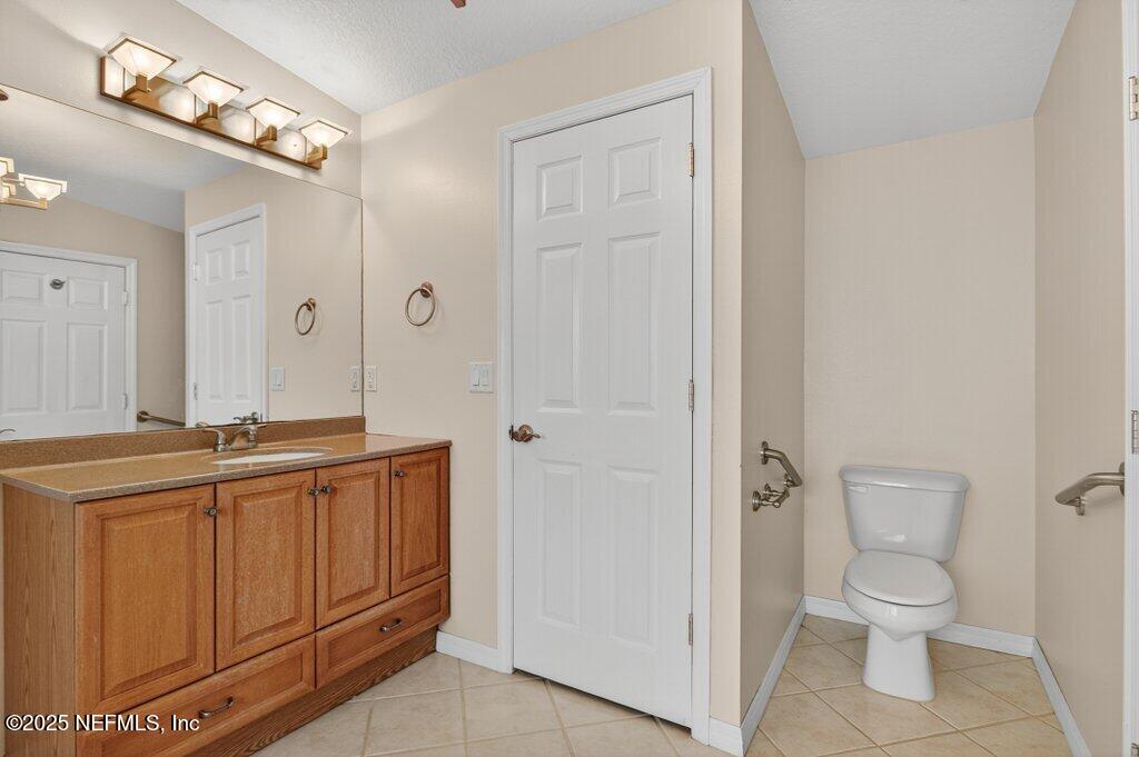 24480 Northeast 127 Street Salt Springs, FL 32134 - Photo 36 of 59 a bathroom with a toilet a sink and mirror