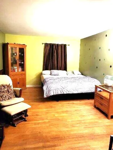 a bedroom with a bed and dresser