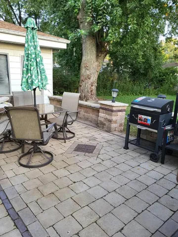 a view of a patio with couple of chairs and a couch