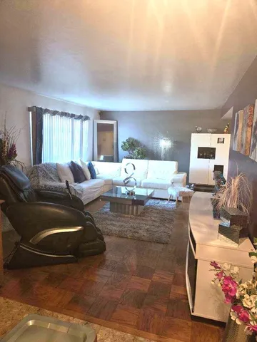 a living room with furniture a couch and a window