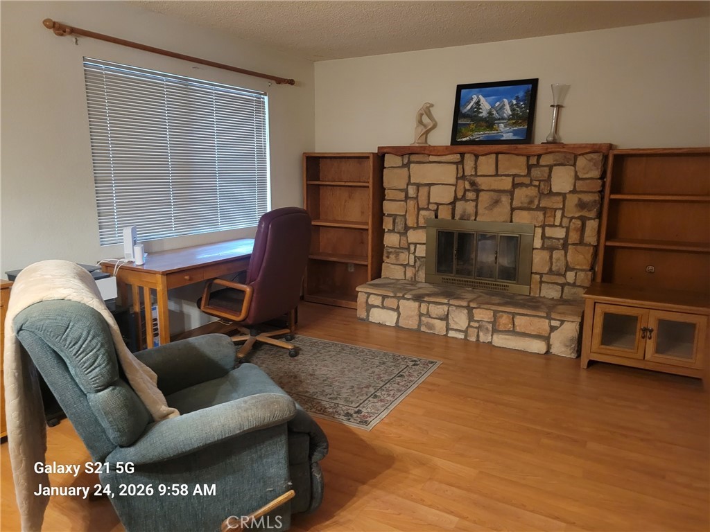 41367 Shadow Palm Way Hemet, CA 92544 - Photo 3 of 35 a living room with furniture a flat screen tv and a fireplace