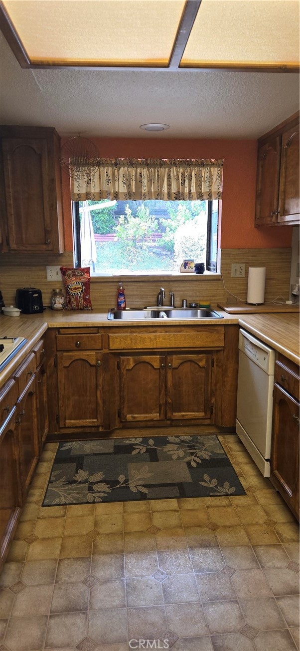 41367 Shadow Palm Way Hemet, CA 92544 - Photo 33 of 35 a kitchen with a sink a stove top oven and cabinetry