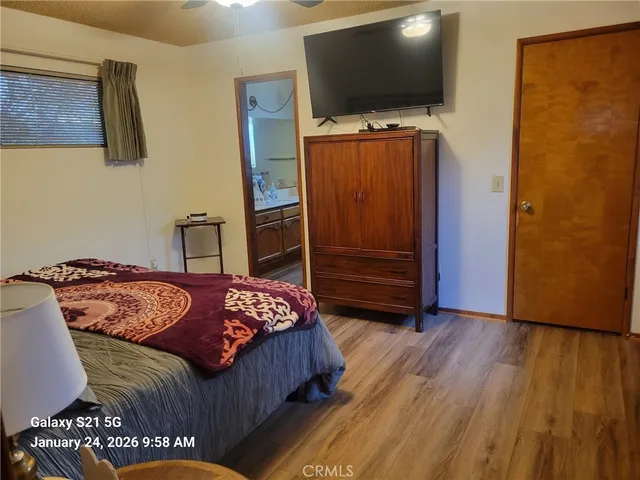 a bedroom with a bed and flat screen tv