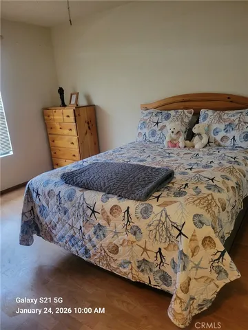 a bed sitting in a bedroom next to a bed