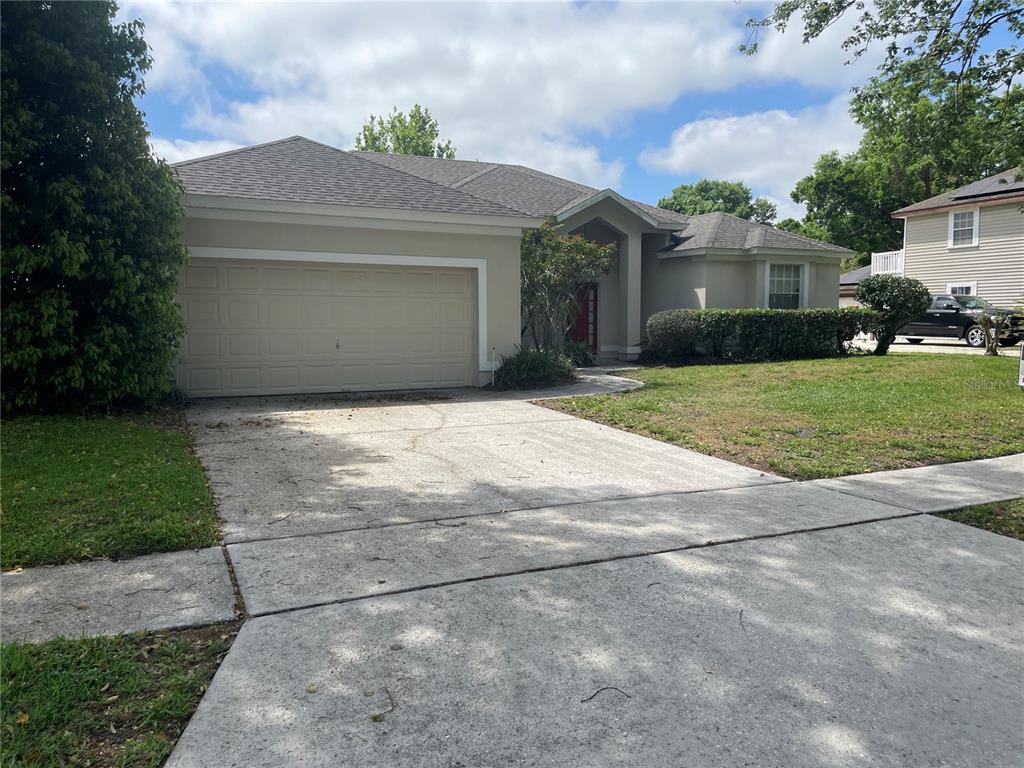 703 Kelly's Cove Ocoee, FL 34761 - Photo 1 of 1 a front view of a house with a yard and a garage