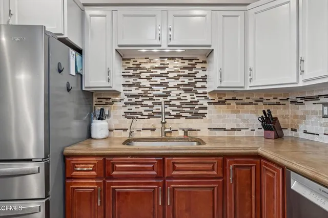 a kitchen with a sink a stove and cabinets