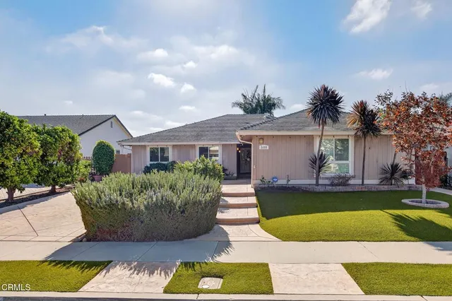 a view of a house with swimming pool and a yard