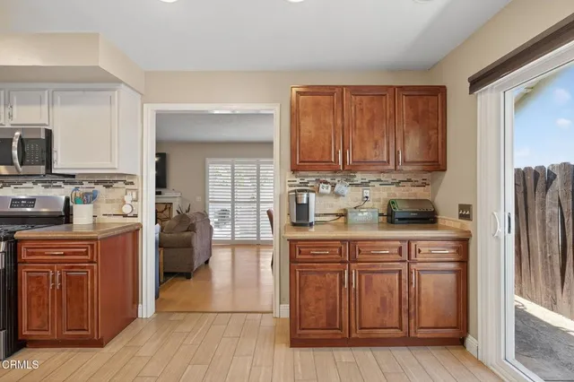 a living room with furniture and a baby crib