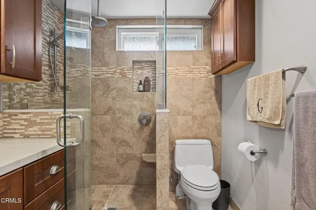 a bedroom with a bed ceiling fan and a window