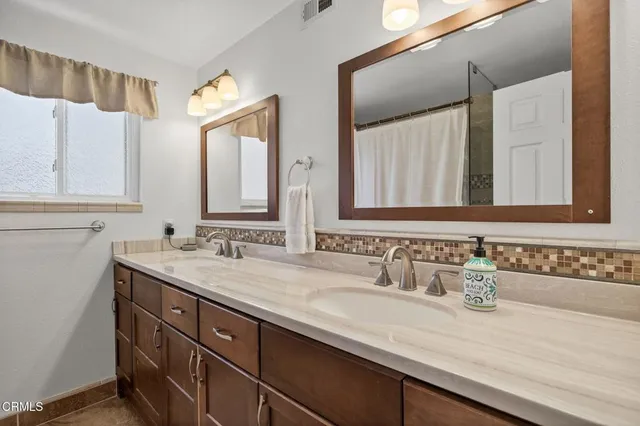a bathroom with a sink a mirror and a toilet