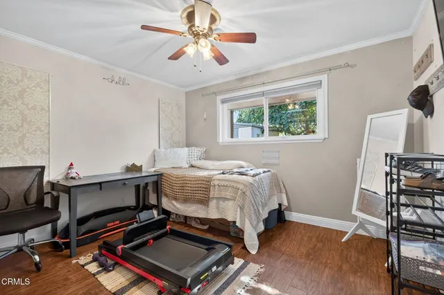 a view of a workspace with furniture and a book shelf