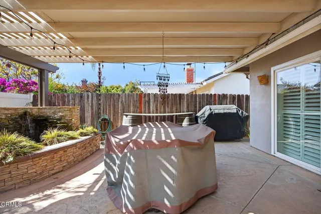 a view of a patio with table and chairs and potted plants